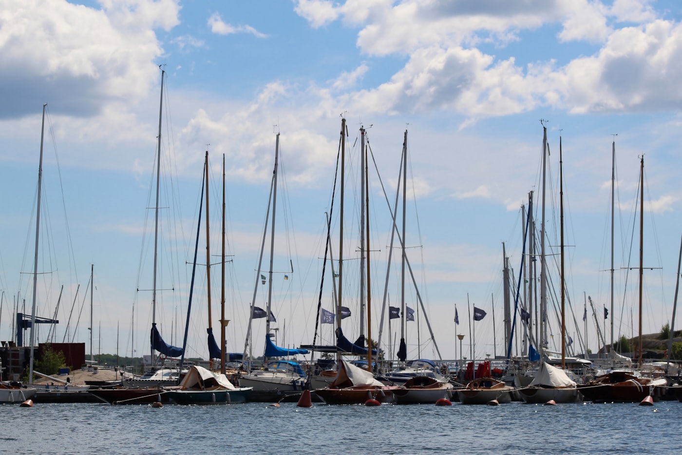 Dinghies and masts in a club boat park under an open sky.